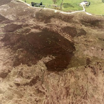 Cnoc Cairaidh, Achnagarron, oblique aerial view, taken from the NE, centred on an area with hut-circles, a field-system and possible cord rig. Standing stones and a building are visible in the top right-hand corner of the photograph.