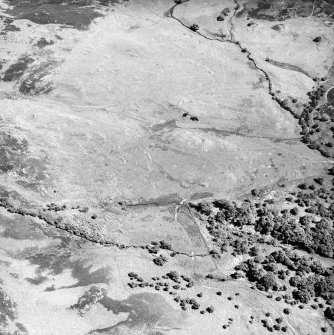 Morvich burn, oblique aerial view, taken from the SW, centred on a township. Enclosures, a building and a structure are visible in the bottom left-hand corner of the photograph.