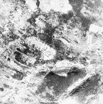Oblique aerial view centred on the remains of the hut-circle and field system, taken from the S.