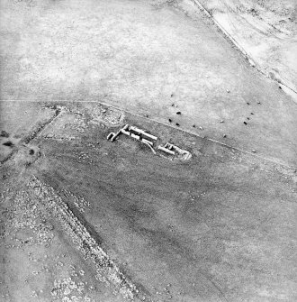 Oblique aerial view centred on the remains of the farmstead, taken from the SE.