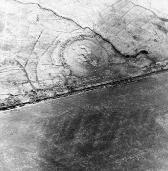 Oblique aerial view centred on the remains of the broch and sheepfolds, taken from the SE.