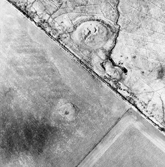 Oblique aerial view of the remains of the broch, cairn and sheepfolds, taken from the ESE.
