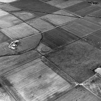 Carin of Humster, oblique aerial view, taken from the SW, showing the remains of a broch in the centre of the photograph.