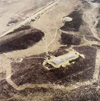 Oblique aerial view centred on the remains of the chambered 
cairns, taken from the NW.
