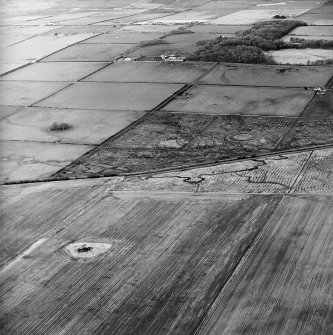 General oblique aerial view looking across the remains of the fort and possible broch towards the country house and farmsteading, taken from the SSE