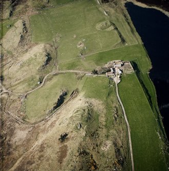 Oblique aerial view of the remains of the brochs and cairn, taken from the S.