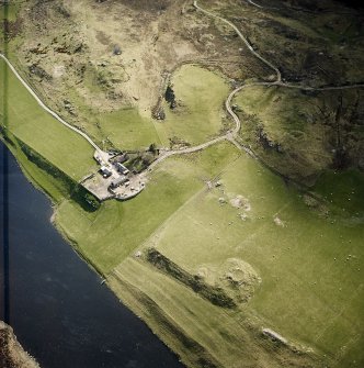 Oblique aerial view of the remains of the brochs and cairn, taken from the NE.