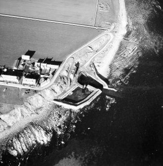 Oblique aerial view of Keiss Harbour and broch.