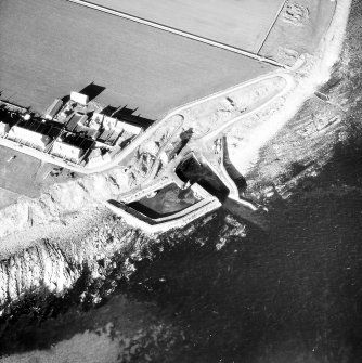 Oblique aerial view of Keiss Harbour and broch.