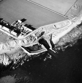 Oblique aerial view of Keiss Harbour and broch.