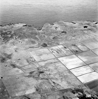 Stroma, oblique aerial view, taken from the E, showing Nethertown township in the right half of the photograph, and Uppertown township in the left half.