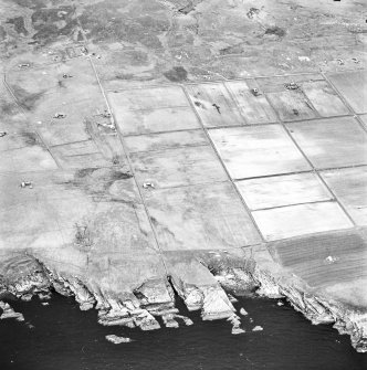 Stroma, oblique aerial view, taken from the E, showing Nethertown township in the right half of the photograph, and Uppertown township in the left half.