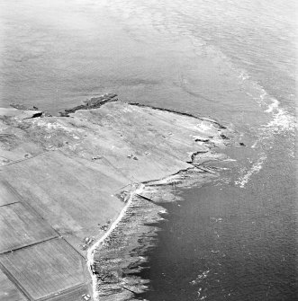 Stroma, oblique aerial view, taken from the ESE, showing Nethertown township in the centre of the photograph, and Stroma lighthouse in the centre right.