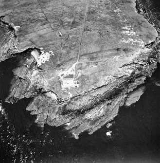 Stroma, oblique aerial view, taken from the N, centred on the lighthouse, and showing the edge of Nethertown township in the top half of the photograph.