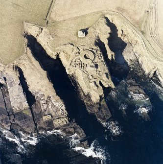 Oblique aerial view of the commemorative monument and the remains of the broch, taken from the E.