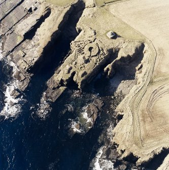 Oblique aerial view of the commemorative monument and the remains of the broch, taken from the NE.