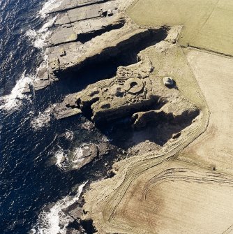 Oblique aerial view of the commemorative monument and the remains of the broch, taken from the N.