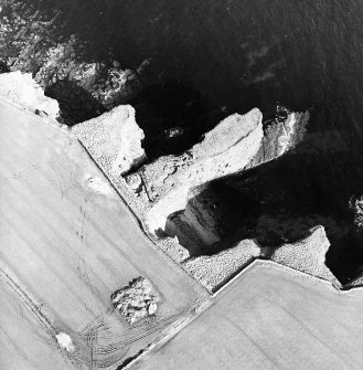 Oblique aerial view centred on the remains of the broch, taken from the S.