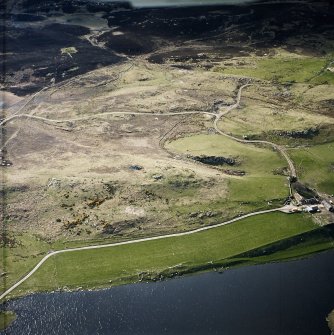 Oblique aerial view centred on the remains of the broch and cairn, taken from the ESE.