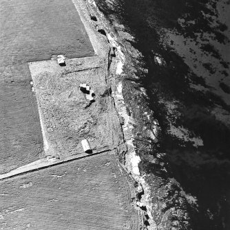 Oblique aerial view of Orkney, Burray, Second World War Northfield coast battery and the Broch of Burray taken from the E.