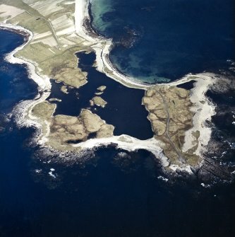 General oblique aerial view looking over Rubhe Ardvule, with the remains of the bothies, kelp kilns and the dun adjacent, taken from the NW.