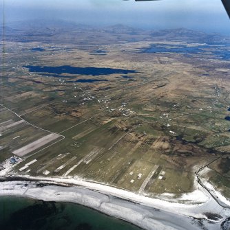 General oblique aerial view looking across the crofting townships of South Boisdale and North Boisdale towards Lochboisdale in the distance, taken from the SW.