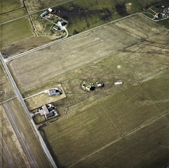 Oblique aerial view centred on the remains of the castle with the remains of the radar station adjacent, taken from the SE.