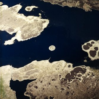 Oblique aerial view centred on the remains of the duns, taken from the WSW.