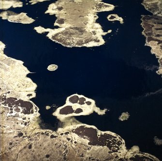 Oblique aerial view centred on the remains of the duns, taken from the S.