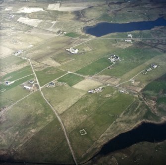 Oblique aerial view centred on the crofting township and remains of the buildings, taken from the W.