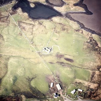 Oblique aerial view centred on the remains of the churches and graveyard, taken from the SE.