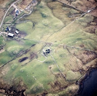 Oblique aerial view centred on the remains of the churches and graveyard, taken from the NNE.