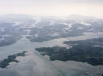 General oblique aerial view over the Isle of Benbecula with Eabhal in the distance, taken from the SW.