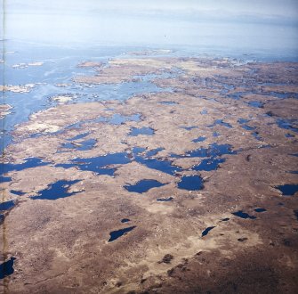 General oblique aerial view looking across the E of the Isle of Benbecula and Loch Uisgebhagh, taken from the WNW.