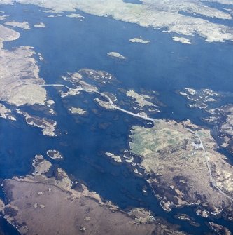 Oblique aerial view centred on the causeway (NF 8424 4653) with the remains of the buildings adjacent, taken from the S.