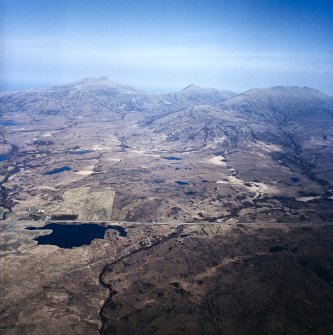 General oblique aerial view looking across South Uist towards Hecla and Beinn Mhor, taken from the W.