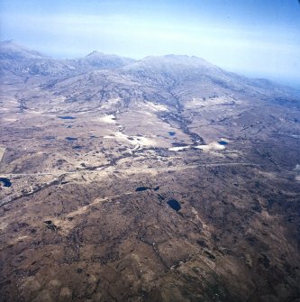 General oblique aerial view looking across South Uist towards Beinn Corradail and Beinn Mhor, taken from the WNW.