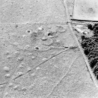 Oblique aerial view of Upperton centred on the remains of hut-circles and a field-system, taken from the NE.