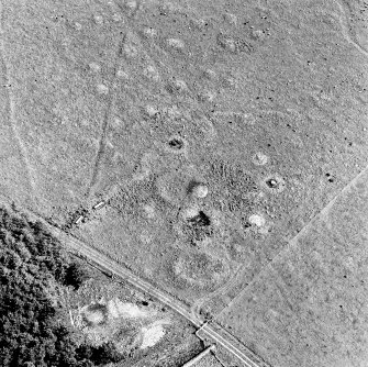 Oblique aerial view of Upperton centred on the remains of hut-circles and a field-system, taken from the W.