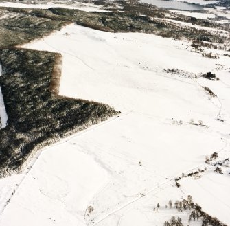 Oblique aerial view of Upperton centred on the remains of hut-circles and a field-system with the same and cairns, small cairns and a field bank adjacent, taken from the W.