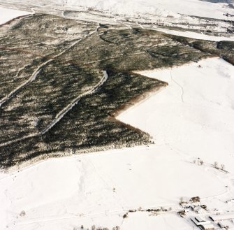 Oblique aerial view of Upperton centred on the remains of hut-circles and a field-system with cairns adjacent, taken from the SW.