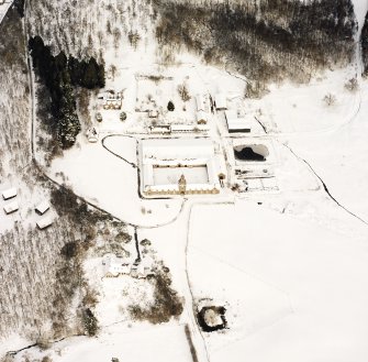 Oblique aerial view of Guisachan centred on a farmsteading, taken from the SW.