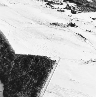 Oblique aerial view of Upperton centred on the remains of hut-circles and a field-system with the same adjacent, taken from the NW.