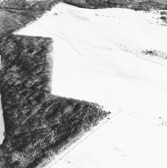 Oblique aerial view of Upperton centred on the remains of hut-circles and a field-system with the same adjacent, taken from the W.