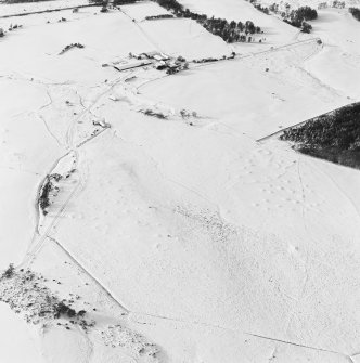 Oblique aerial view of Upperton centred on the remains of hut-circles and a field-system with the same and cairns adjacent, taken from the E.