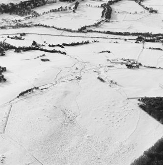 Oblique aerial view of Upperton centred on the remains of hut-circles and a field-system with the same adjacent, taken from the NE.