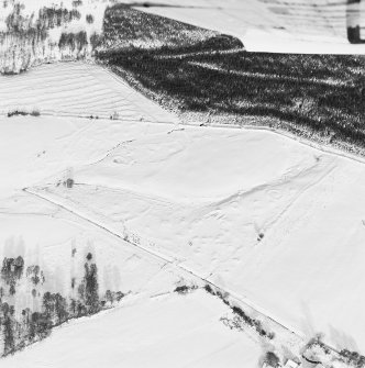 Oblique aerial view of Upperton centred on the remains of hut-circles and a field-system with cairns adjacent, taken from the S.