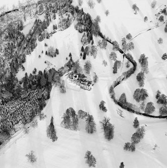 Oblique aerial view of Guisachan House centred on the remains of the country house, taken from the SSW.