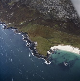 Oblique aerial view centred on the remains of the chapel and broch, taken from the S.