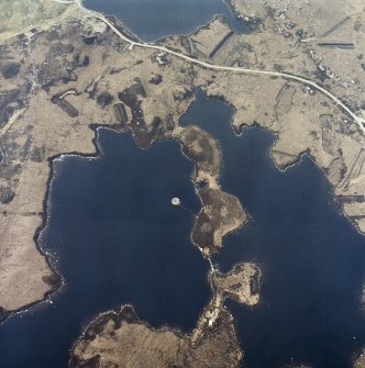 Oblique aerial view centred on the remains of the dun, taken from the E.